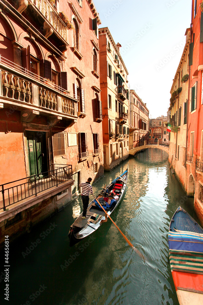 Venice with gondola on canal in Italy