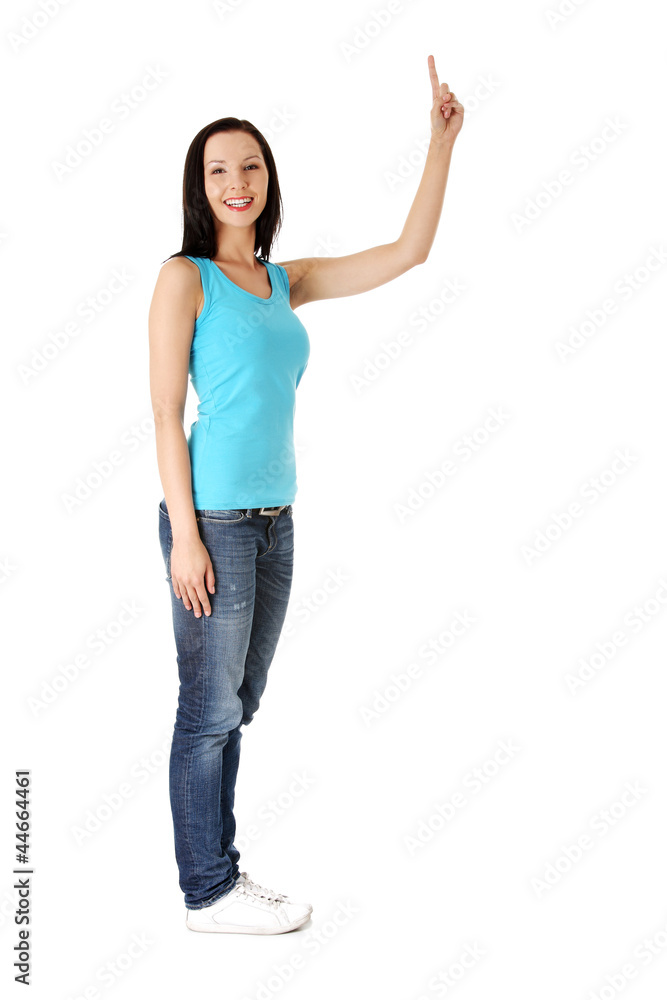Happy , excited young woman pointing on copy space Happy , excited young woman pointing on copy space