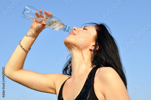 thirsty young woman drinking cold water