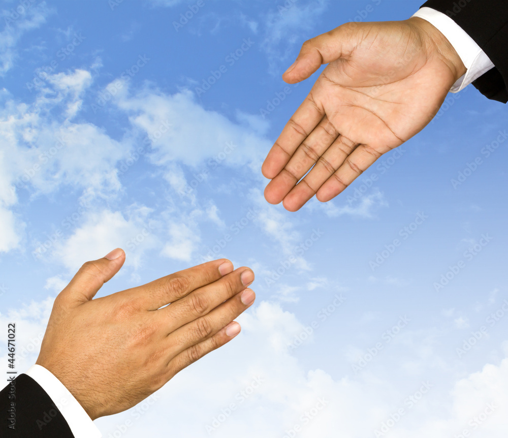 Businessman hand is reaching out in the sky for help Businessman hand is reaching out in the sky for help