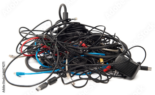 Heap of computer cables isolated on white photo