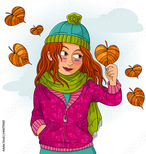 girl holding a heart shaped autumn leaf