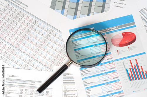 Obraz na plátne magnifying glass over financial reports