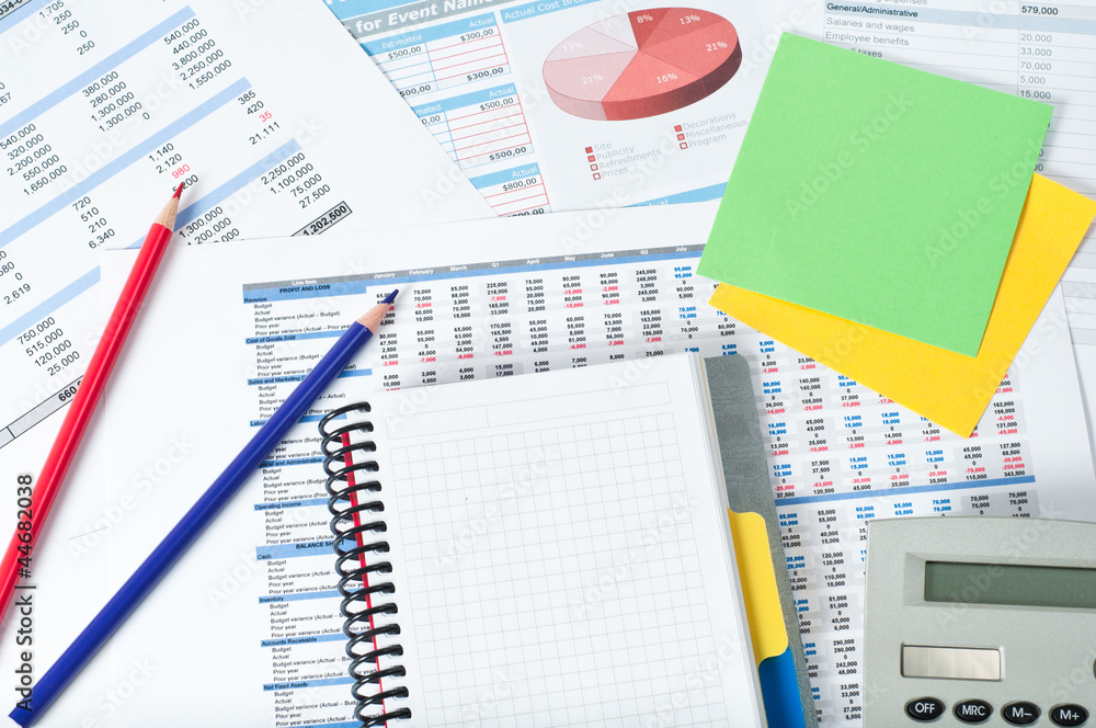 financial documents with notebook and pencils financial documents with notebook and pencils