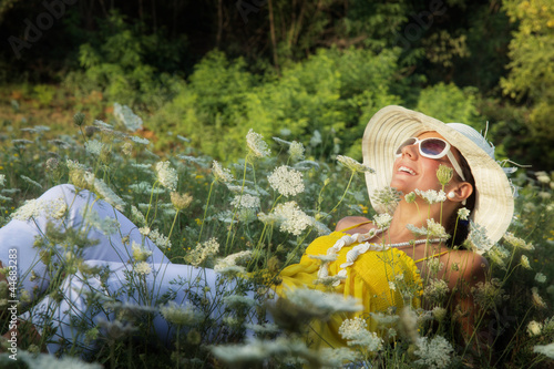 Fototapeta Naklejka Na Ścianę i Meble -  Young woman relaxed in grass