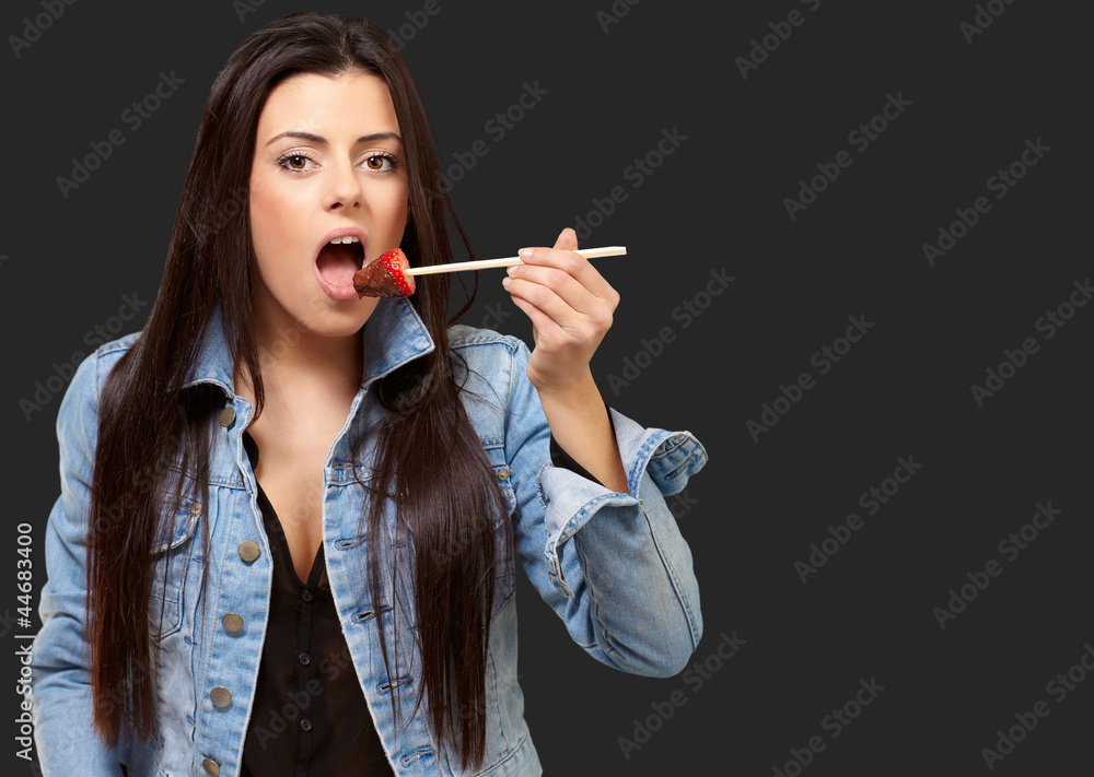 Portrait Of A Female Eating Strawberry With Chocolate Sauce Portrait Of A Female Eating Strawberry With Chocolate Sauce