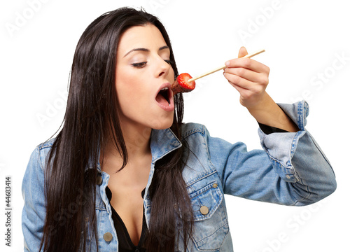 Portrait Of A Female Eating Strawberry With Chocolate Sauce