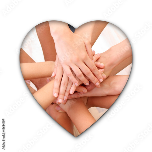 Young hands on top of each other heart