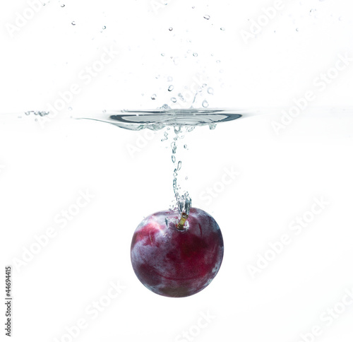 Fresh plum in water splash