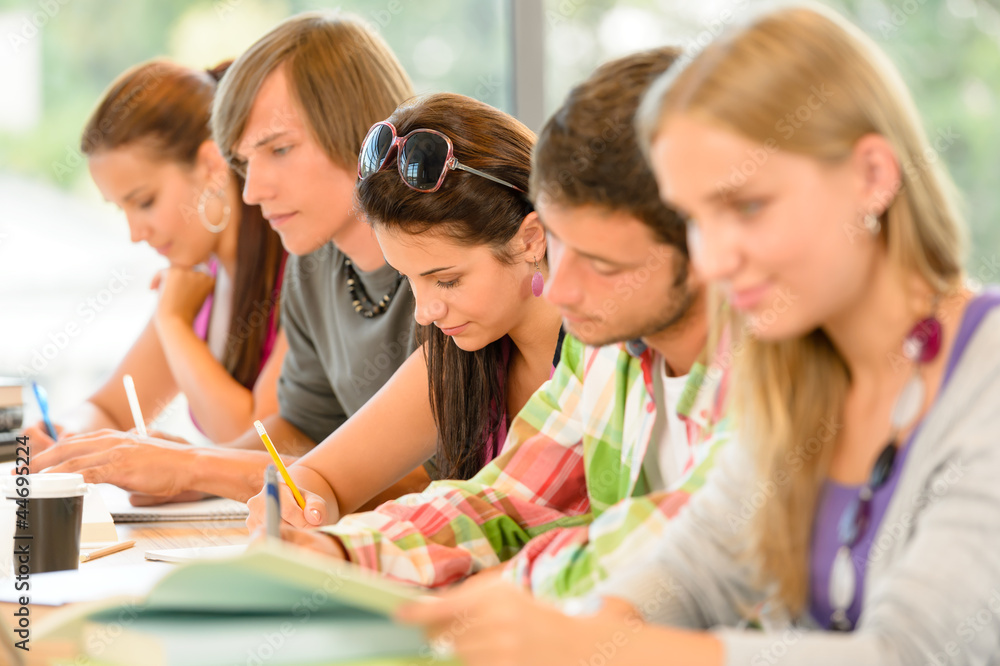 Fototapeta premium Students writing at high-school exam teens study