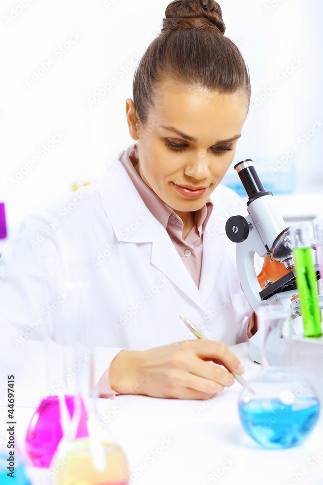 Young female scientist working in laboratory Young female scientist working in laboratory