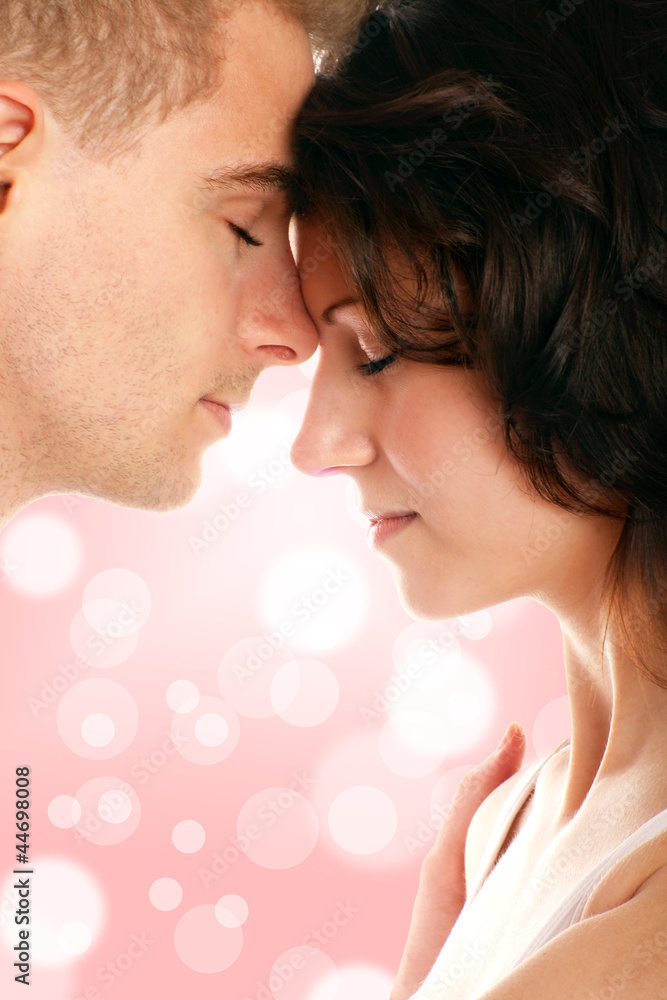 portrait of a young beautiful couple against glossy background portrait of a young beautiful couple against glossy background