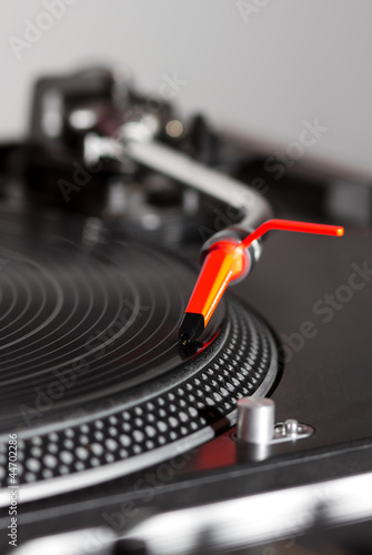 Turntable playing vinyl record photo