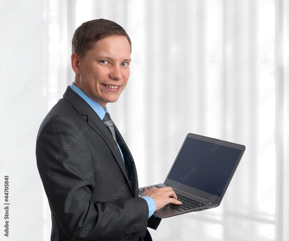 businessman with laptop computer in office businessman with laptop computer in office