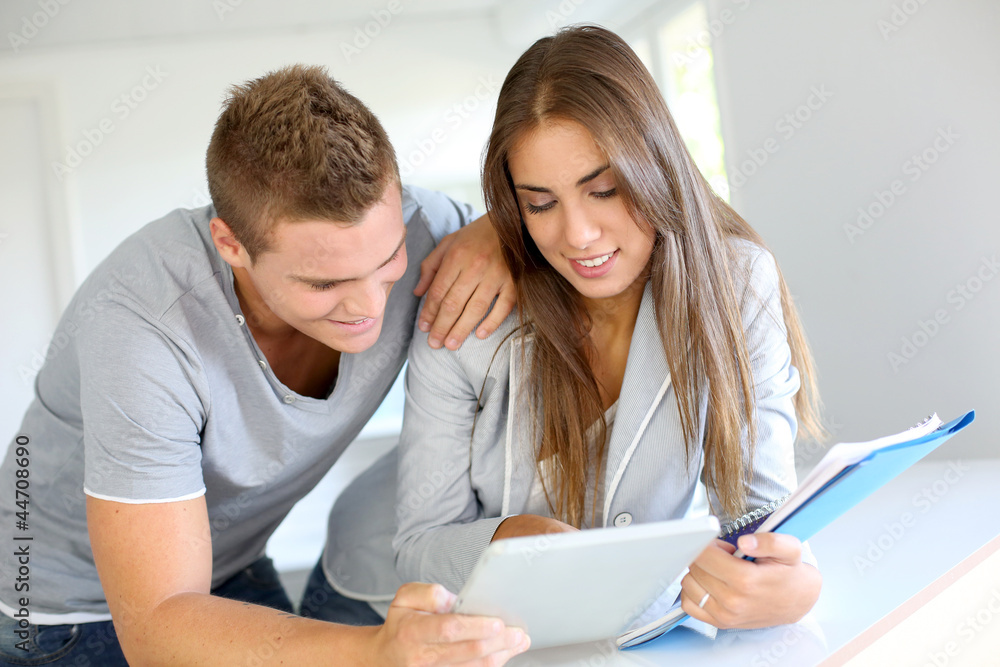 Portrait of cheerful students connected on digital tablet Portrait of cheerful students connected on digital tablet