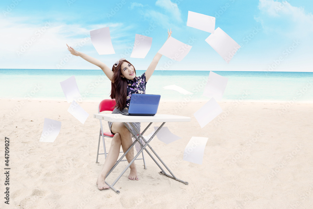 Young asian businesswoman expressing her success at beach