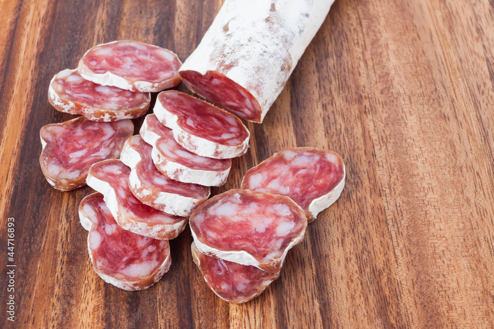 salami sausage on wooden background salami sausage on wooden background