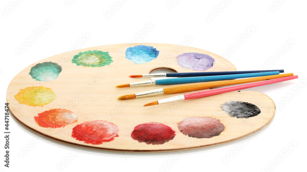 wooden art palette with paint and brushes isolated on white wooden art palette with paint and brushes isolated on white