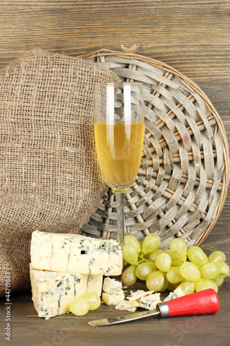 composition of blue cheese and a glass of wine with grapes