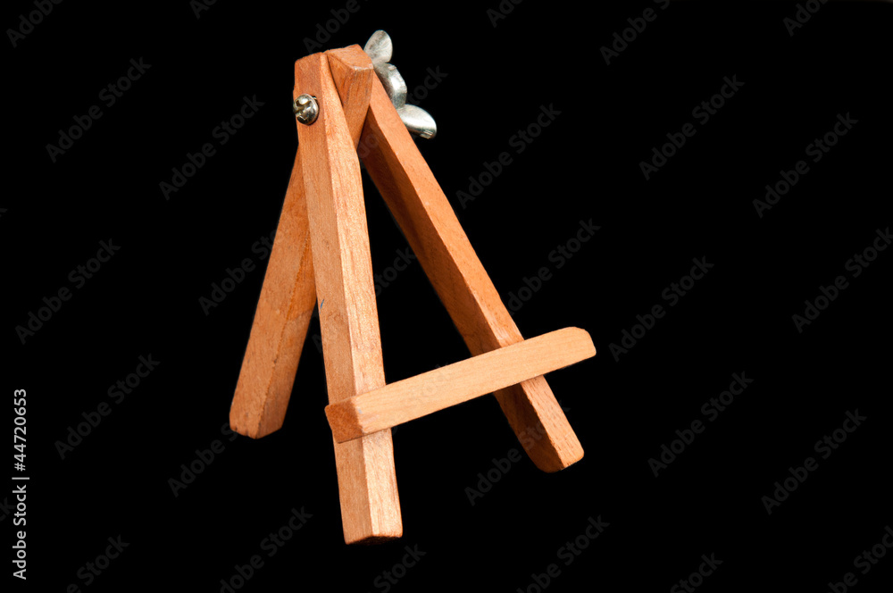 Small tripod for painting without canvas over a black background Small tripod for painting without canvas over a black background