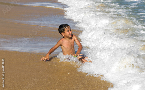 Boy playing in the waves