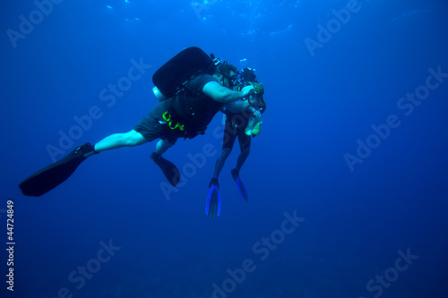 Two diver gathering shells, Cuba