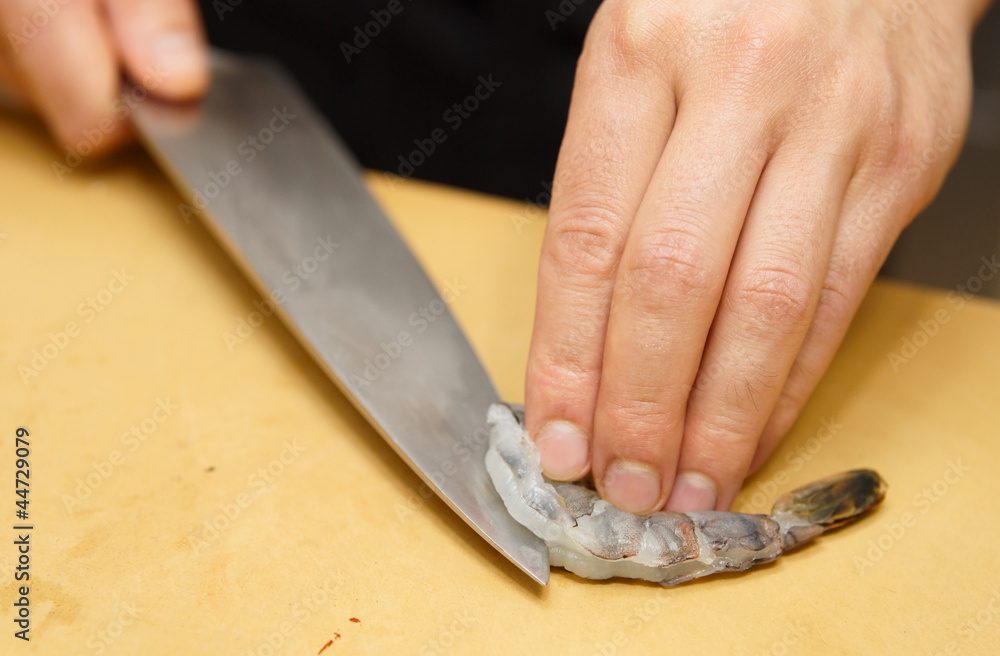 Chef is cutting raw shrimp