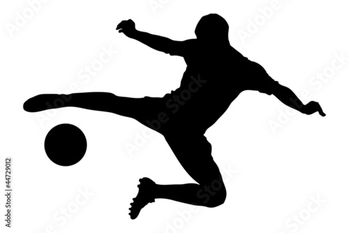 A silhouette of a soccer player shooting a ball