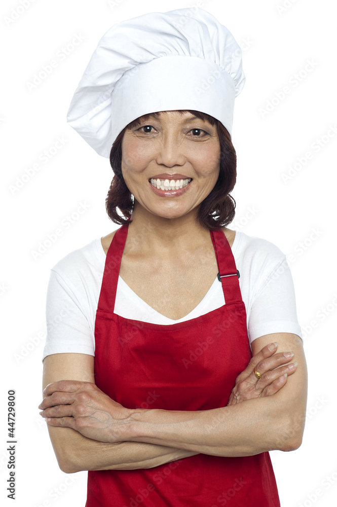 Confident smiling chef posing with her arms crossed Confident smiling chef posing with her arms crossed