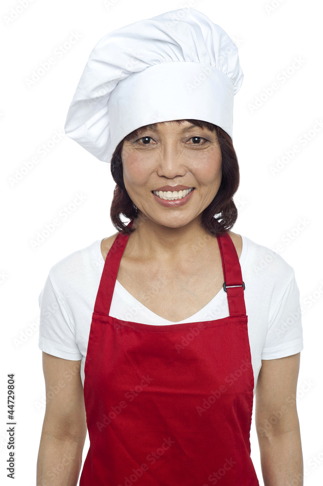 Young smiling female chef wearing red apron Young smiling female chef wearing red apron