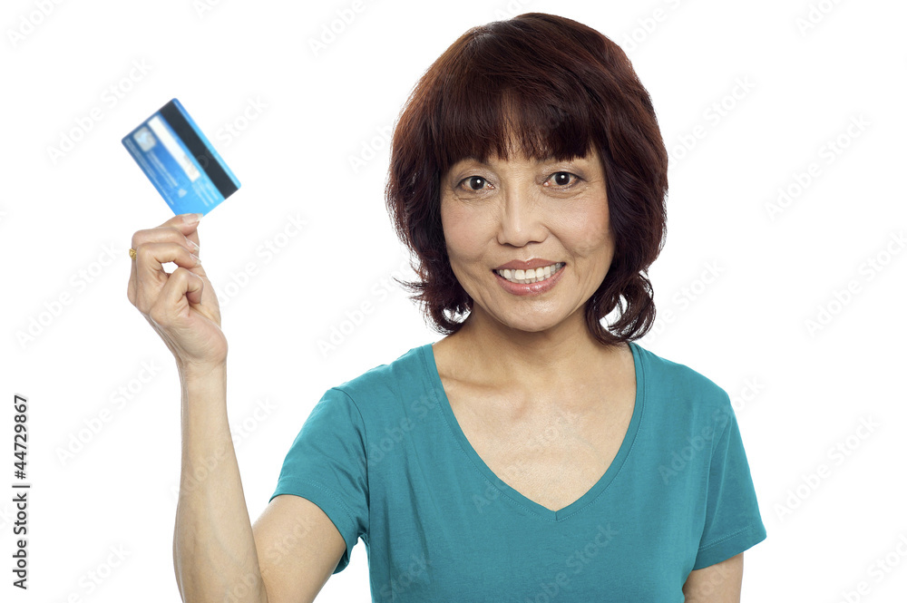 Beautiful woman holding her credit card out Beautiful woman holding her credit card out