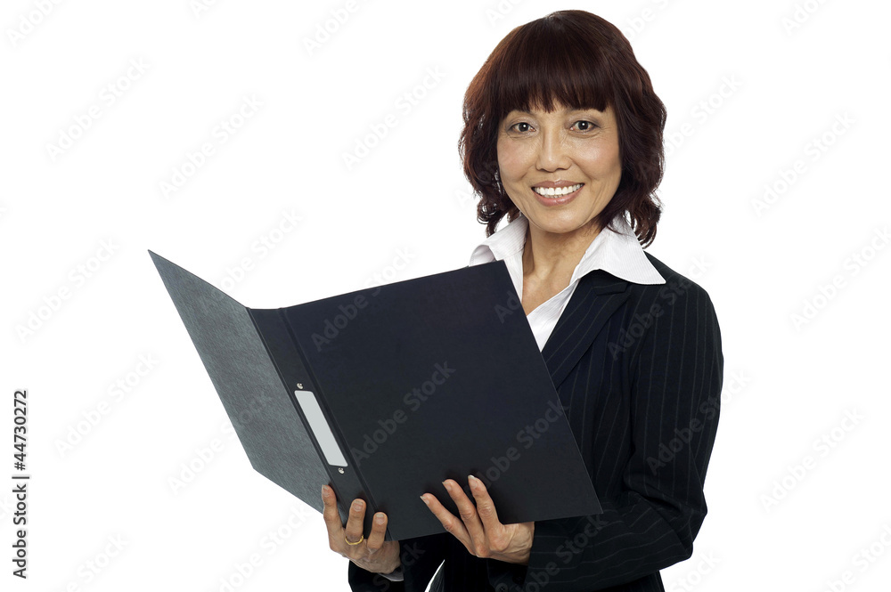Young female asian boss going through the file