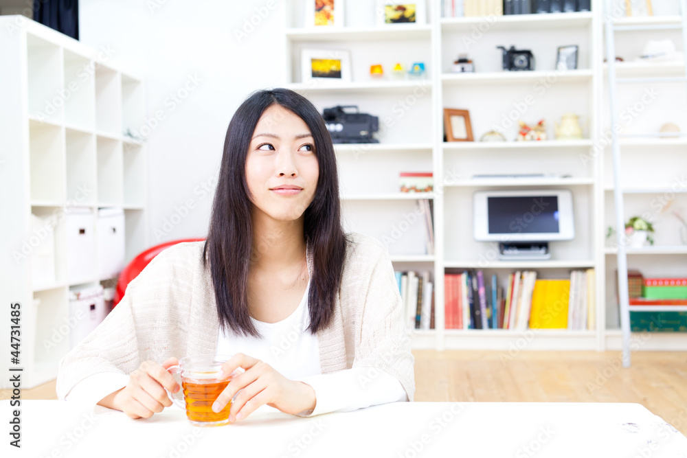 a young asian woman relaxing in the room