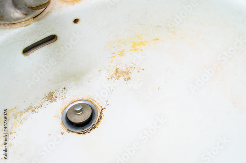 Dirty white ceramic sink never been cleaned.