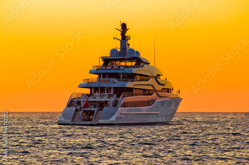Luxury yacht on open sea at sunset
