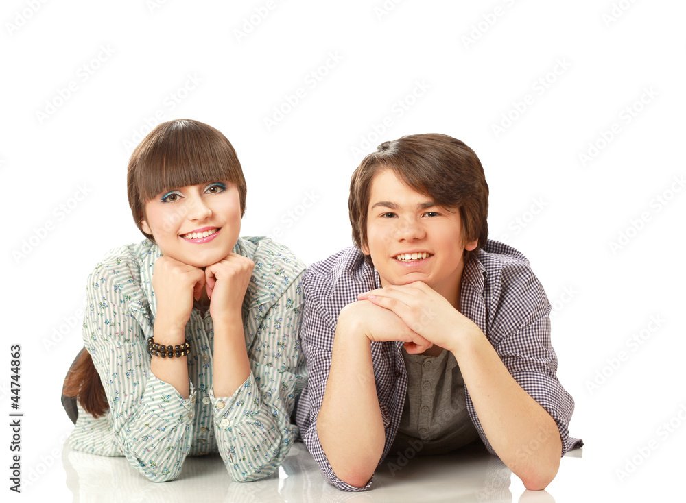 Happy couple lying on floor and smiling at camera Happy couple lying on floor and smiling at camera