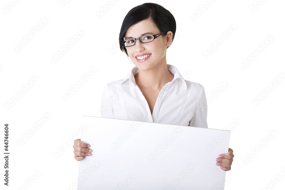 Smiling young business woman showing blank signboard Smiling young business woman showing blank signboard