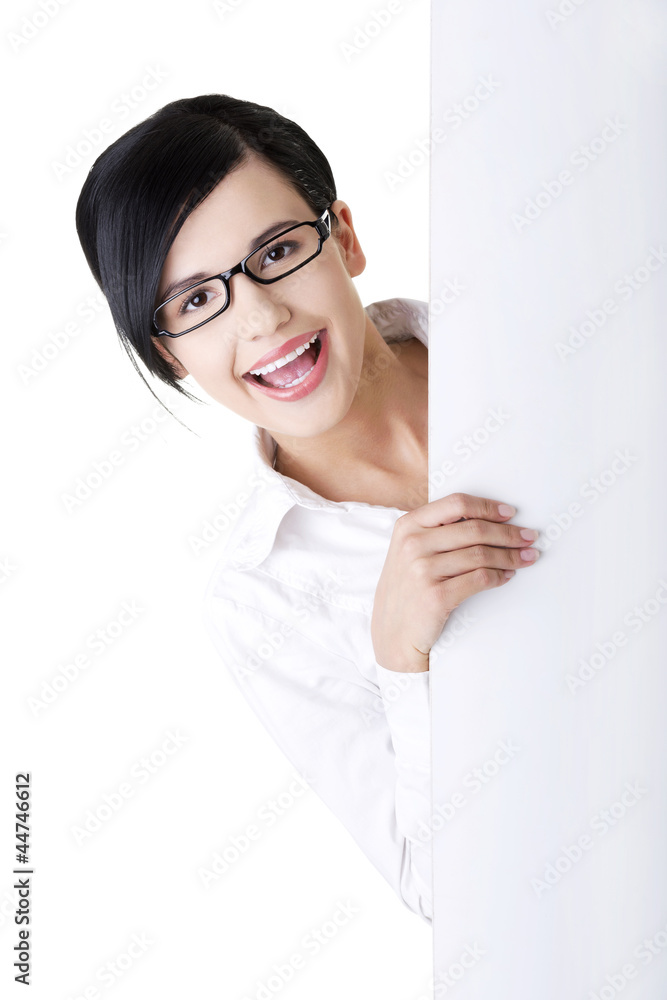 Smiling young business woman showing blank signboard Smiling young business woman showing blank signboard