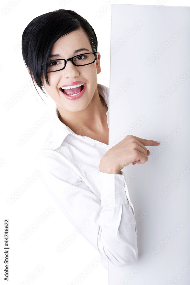 Smiling young business woman showing blank signboard Smiling young business woman showing blank signboard