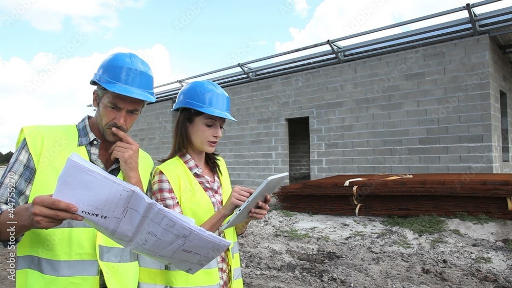 Construction people using electronic tablet on site Construction people using electronic tablet on site