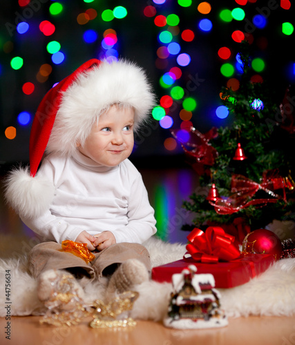 funny baby in Santa Claus h...