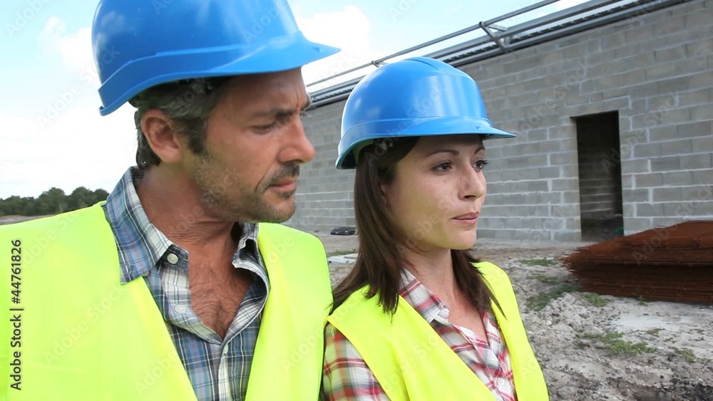 Construction people walking on building site Construction people walking on building site