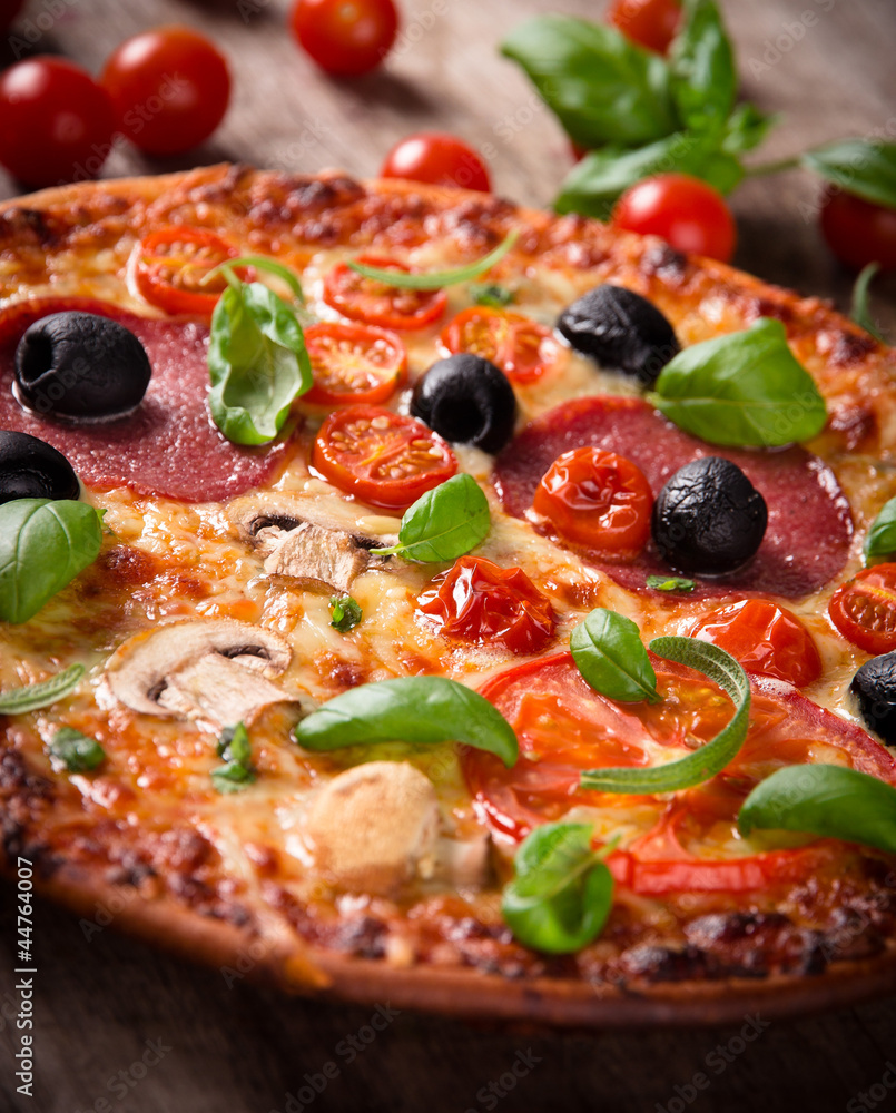 Tasty Italian pizza on wooden background Tasty Italian pizza on wooden background