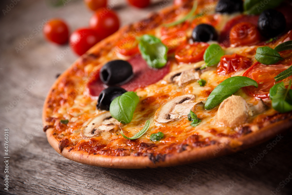 Tasty Italian pizza on wooden background Tasty Italian pizza on wooden background