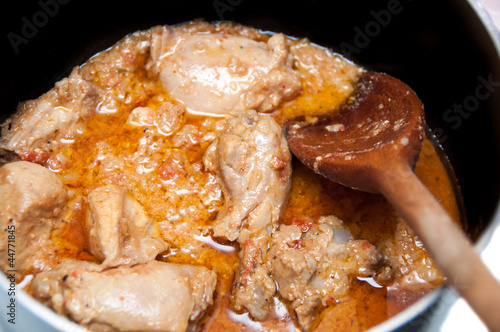 Close up of Chicken curry masal being cooked in a pan