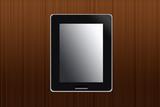 Black abstract tablet computer on wooden background