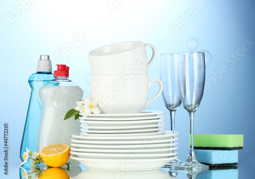 empty clean plates, glasses and cups with dishwashing liquid,