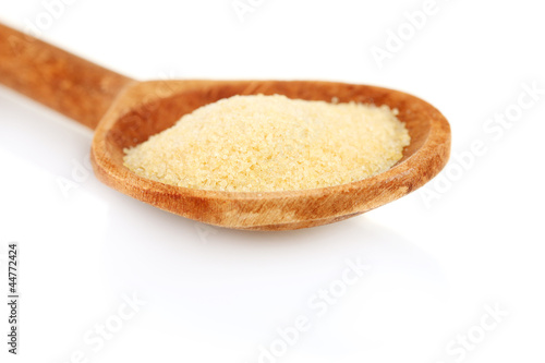 Gelatin in a wooden spoon on white background close-up