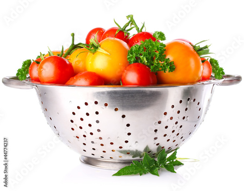 colour tomatos in colander with parsley