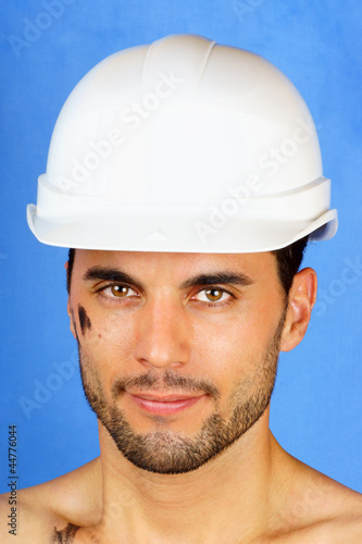 Dirty manual worker with hard hat